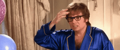 Man In Blue Robe And Glasses Touching Hair GIF