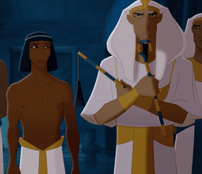 Man In Blue Robe And Hat In Front Of Building GIF