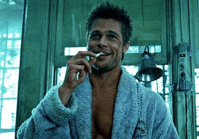 Man In Blue Robe Brushing Teeth And Smoking Cigarette GIF