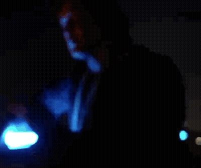 Man In Blue Robe Holding Blue Light GIF