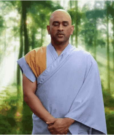 Man In Blue Robe Meditating In Woods GIF