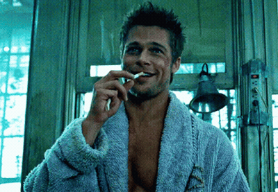 Man In Blue Robe Smoking Cigarette And Smiling GIF
