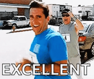 Man In Blue Running Beside Man In Grey GIF