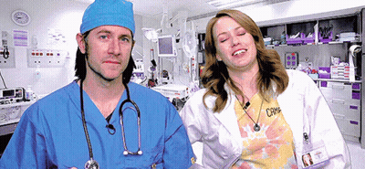 Man In Blue Scrub And Woman In White Lab Coat GIF