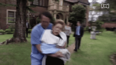 Man In Blue Scrub Carrying Woman In White Towel GIF