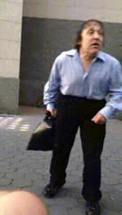 Man In Blue Shirt And Black Pants Holding Hat GIF