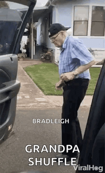 Man In Blue Shirt And Black Pants Next To Car GIF