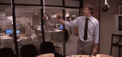 Man In Blue Shirt And Black Tie By Window With Blinds GIF
