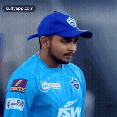 Man In Blue Shirt And Blue Hat Standing On Field GIF