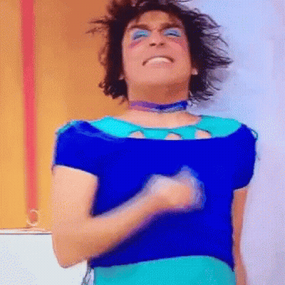 Man In Blue Shirt And Eye Shadow Dancing GIF