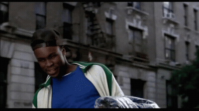 Man In Blue Shirt And Green Jacket Carrying Trash Bag GIF