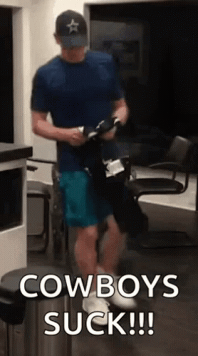 Man In Blue Shirt And Hat Holding Cowboy Boots GIF