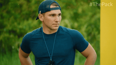 Man In Blue Shirt And Hat In Front Of Yellow Wall With #Thepack GIF