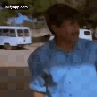 Man In Blue Shirt And Mustache Standing In Front Of Bus GIF