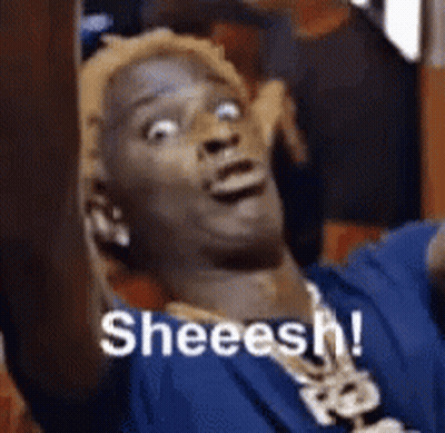 Man In Blue Shirt And Necklace Making Funny Face Saying Sheeesh GIF