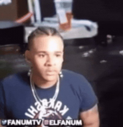 Man In Blue Shirt And Necklace Sitting At Computer GIF
