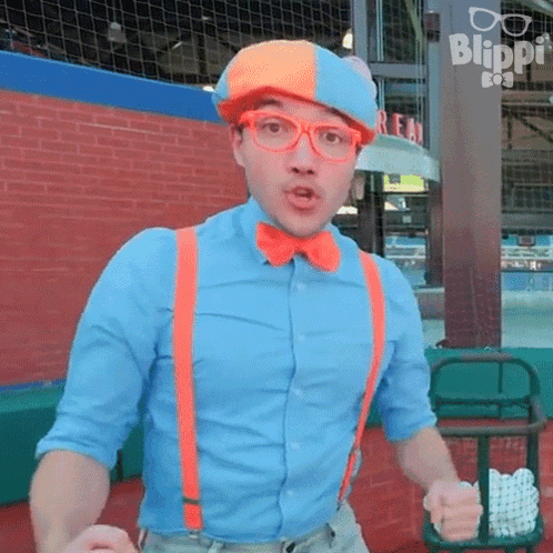 Man In Blue Shirt And Orange Suspenders In Front Of Blippi Sign GIF