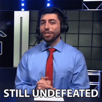 Man In Blue Shirt And Red Tie Saying Still Undefeated GIF