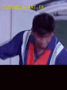 Man In Blue Shirt And Red Vest GIF