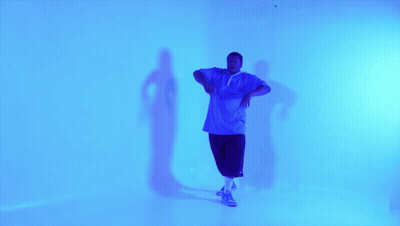 Man In Blue Shirt And Shorts Dancing GIF