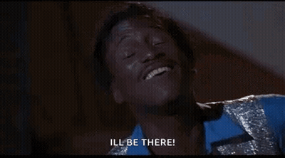 Man In Blue Shirt And Silver Jacket Smiling Saying Ill Be There GIF