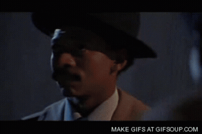Man In Blue Shirt And Silver Vest Smiling GIF
