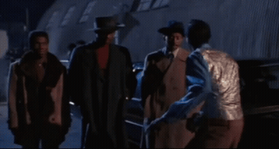 Man In Blue Shirt And Silver Vest Smiling GIF