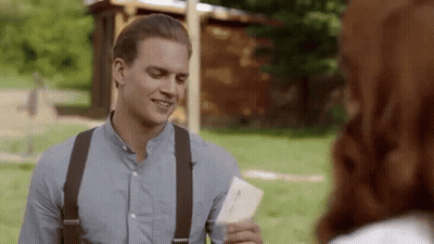 Man In Blue Shirt And Suspenders Holding Paper GIF