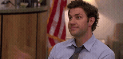 Man In Blue Shirt And Tie Before American Flag GIF