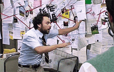 Man In Blue Shirt And Tie Before Bulletin Board GIF
