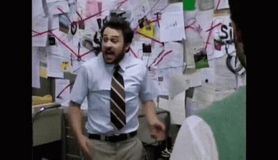 Man In Blue Shirt And Tie By Wall With Papers GIF