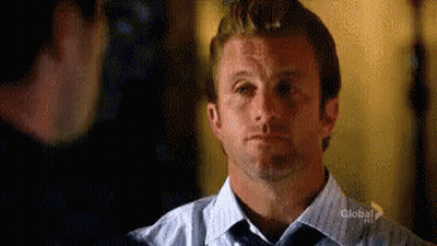 Man In Blue Shirt And Tie Looking At Man In Black Shirt GIF