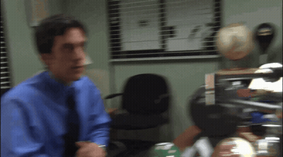 Man In Blue Shirt And Tie Standing By Window GIF