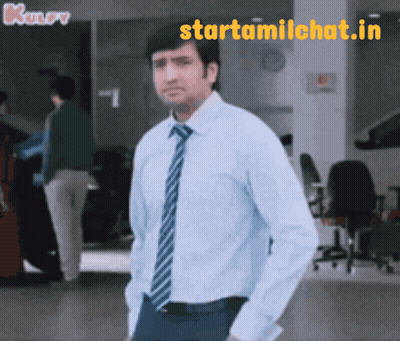 Man In Blue Shirt And Tie Standing In Front Of Starttamilchat.in Sign GIF