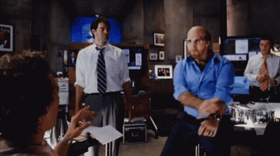 Man In Blue Shirt And Tie Standing In Room GIF