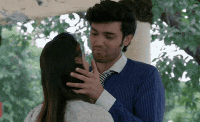 Man In Blue Shirt And Tie Touching Woman's Head GIF
