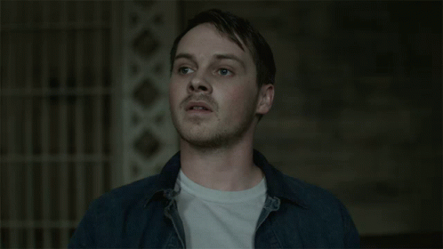 Man In Blue Shirt And White T-Shirt Looks Up GIF