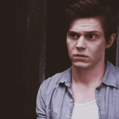 Man In Blue Shirt And White Tank Top Standing In Front Of Door GIF