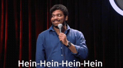 Man In Blue Shirt At Microphone Saying Hein-Hein-Hein GIF