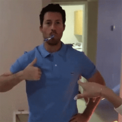 Man In Blue Shirt Brushing Teeth GIF