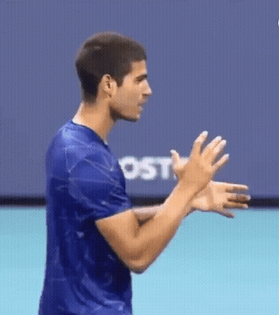 Man In Blue Shirt Clapping In Front Of Screen GIF