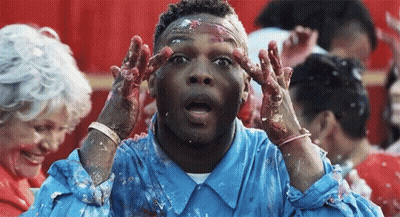 Man In Blue Shirt Covered In Cake Icing GIF