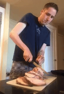 Man In Blue Shirt Cutting Meat GIF