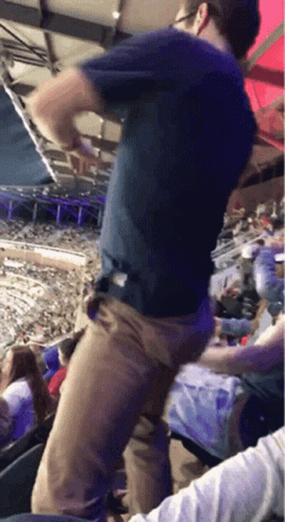 Man In Blue Shirt Dancing In Crowded Stadium GIF