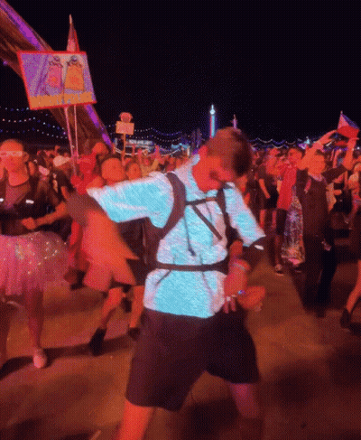 Man In Blue Shirt Dancing In Front Of I Love You Sign GIF