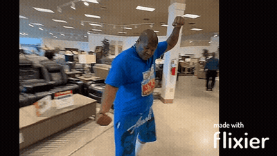 Man In Blue Shirt Dancing In Store With Flixier GIF