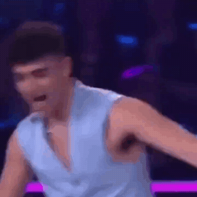 Man In Blue Shirt Dancing On Stage GIF