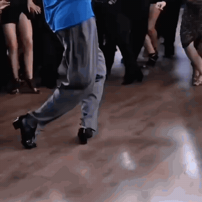 Man In Blue Shirt Dancing On Wooden Floor GIF