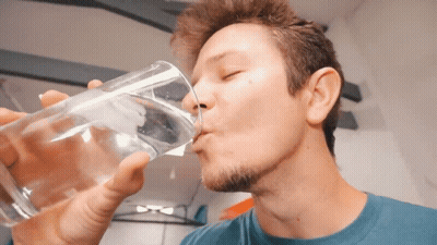 Man In Blue Shirt Drinking From Glass GIF