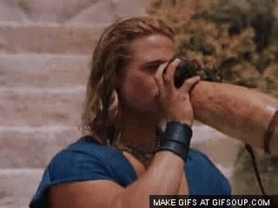 Man In Blue Shirt Drinking From Long Horn GIF